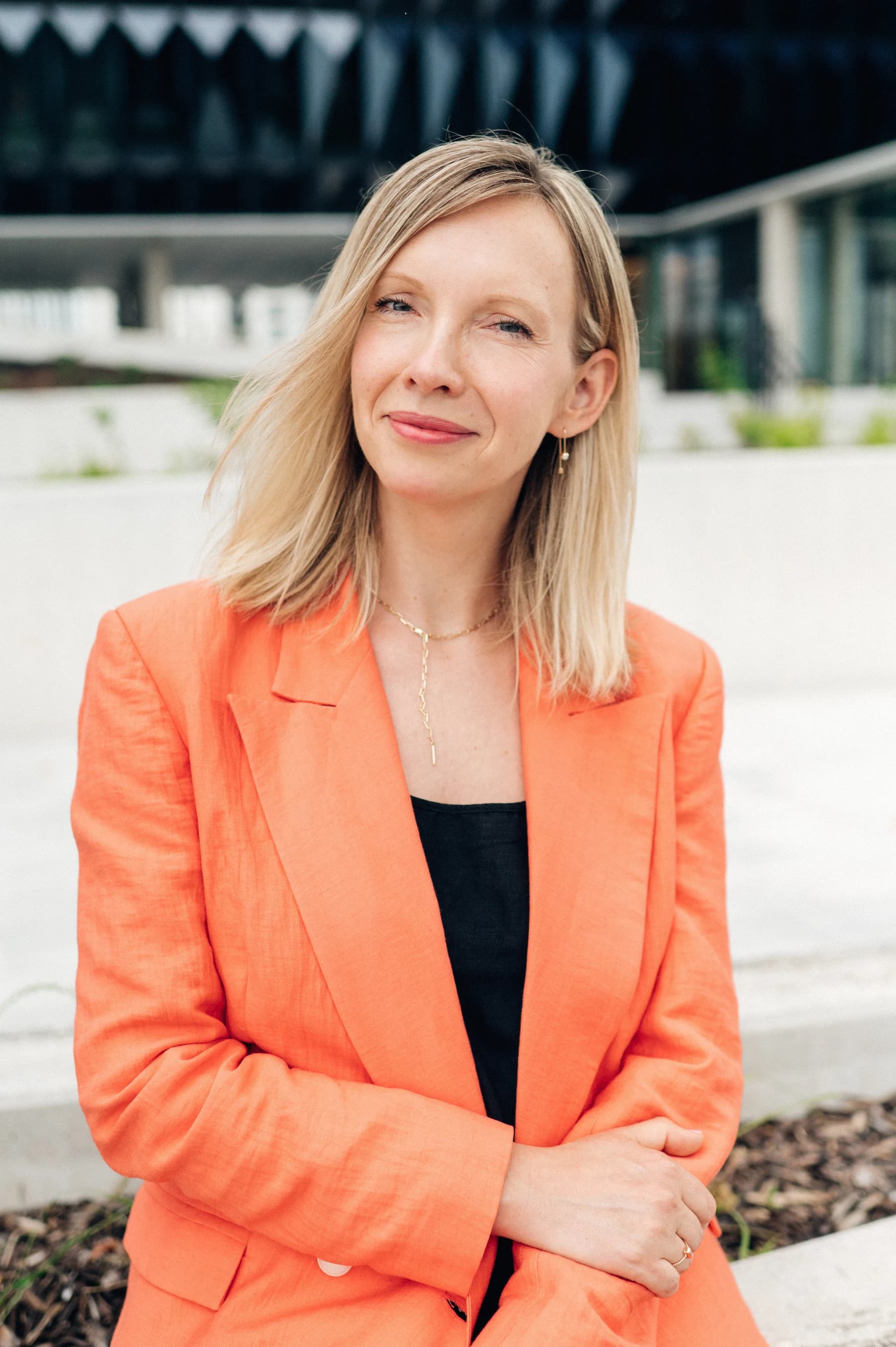 Dana Rollinger wearing an orange blazer outdoors
